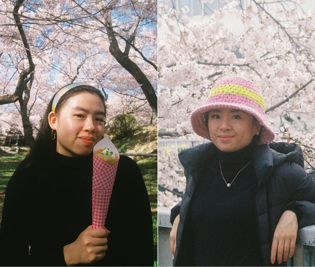 Womb Mate founders and designers, Rainie and Jenny pose in front of a garden of blooming cherry blossom trees in Japan.